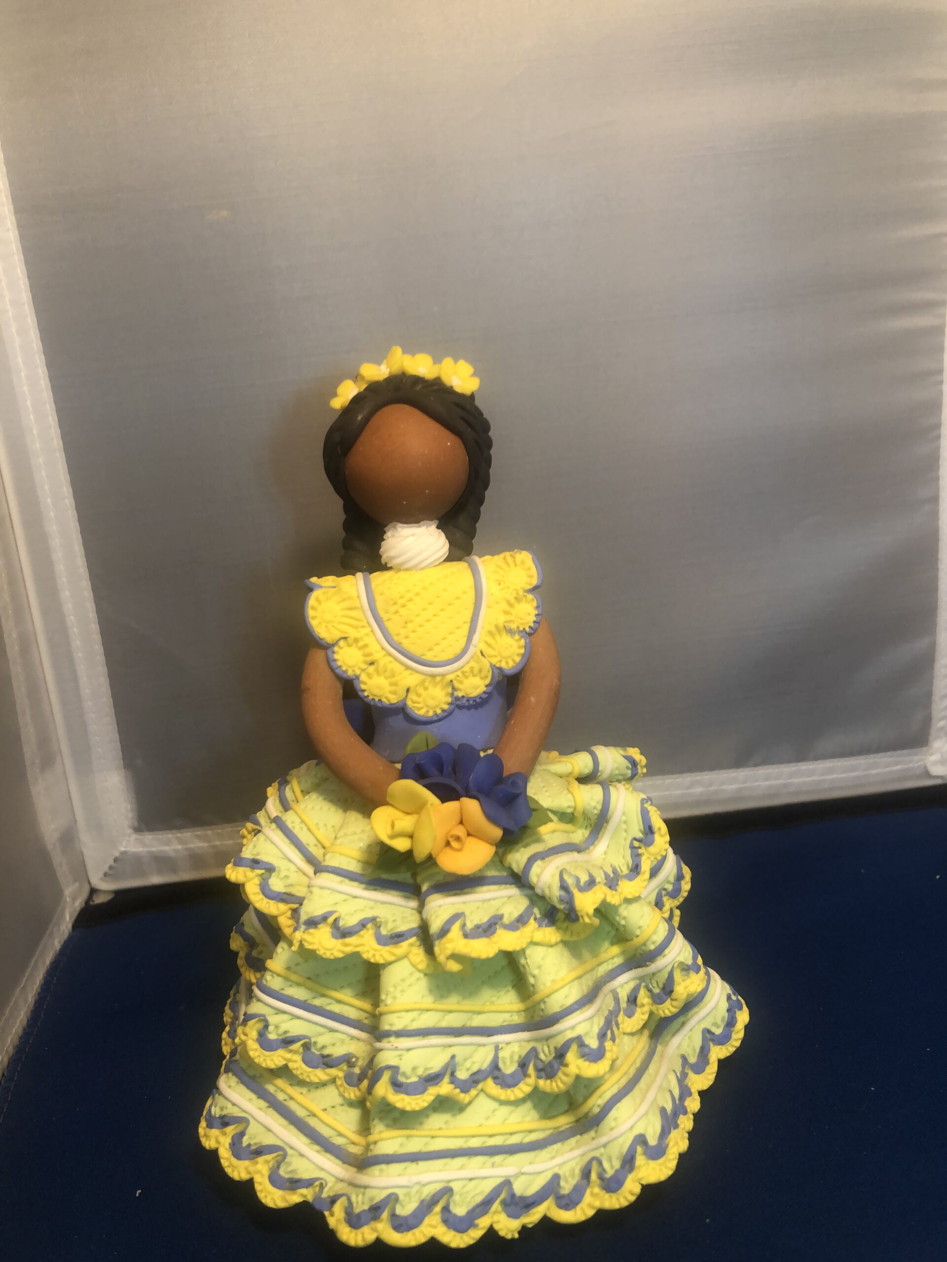 Handmade cloth doll in yellow and blue dress