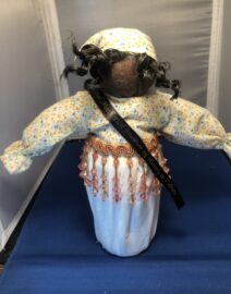 Handmade fabric doll with beaded fringe belt