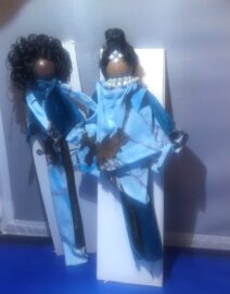 Two handmade cloth dolls wearing blue outfits