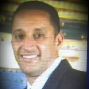 Smiling businessman headshot with blurred background