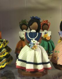 Handmade clay dolls in colorful traditional dresses