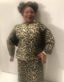 Smiling doll wearing leopard-print outfit