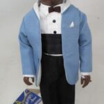 Smiling doll in blue jacket and tuxedo